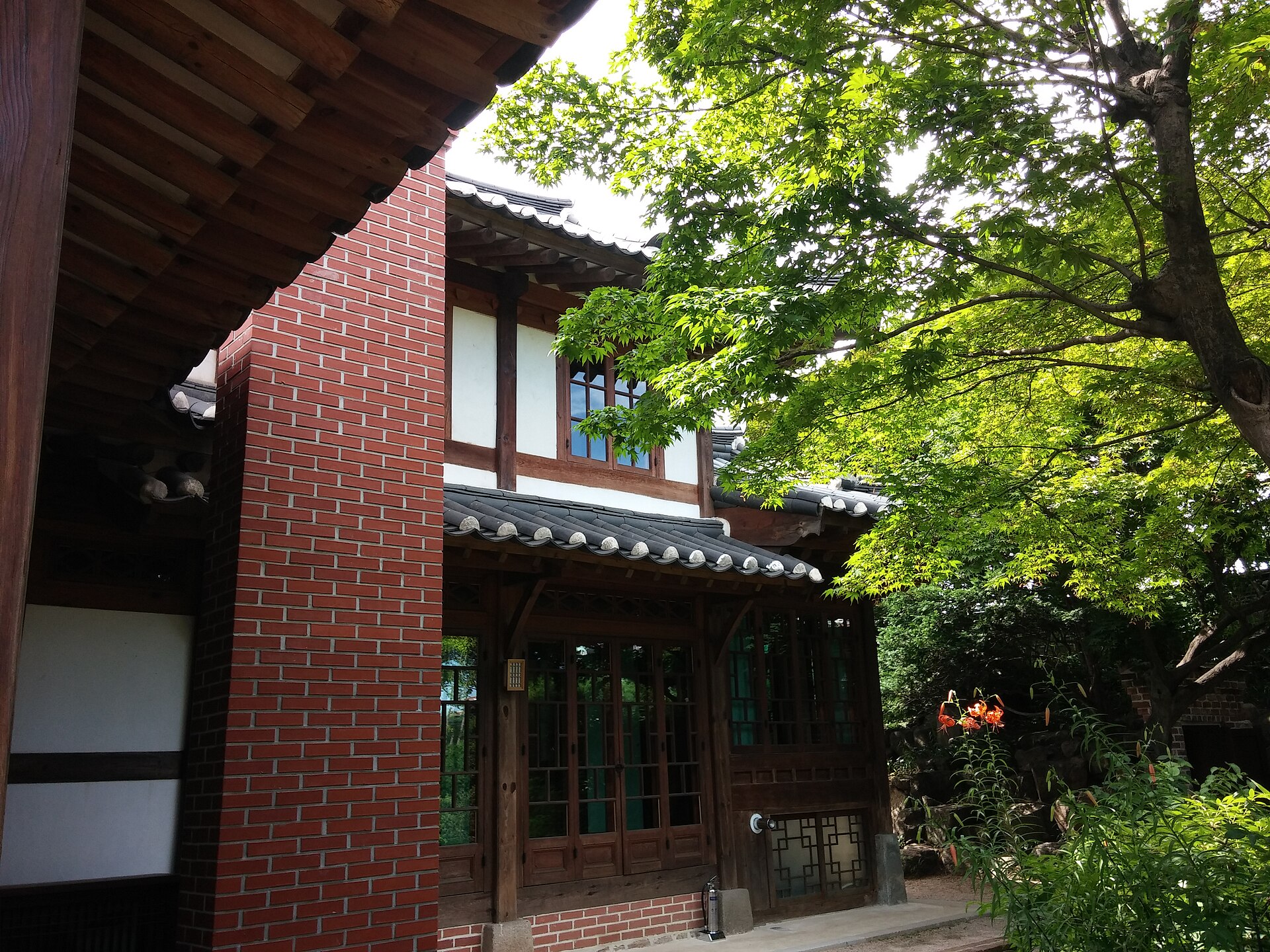 Roof tiles, red brick and glazing in the same building.