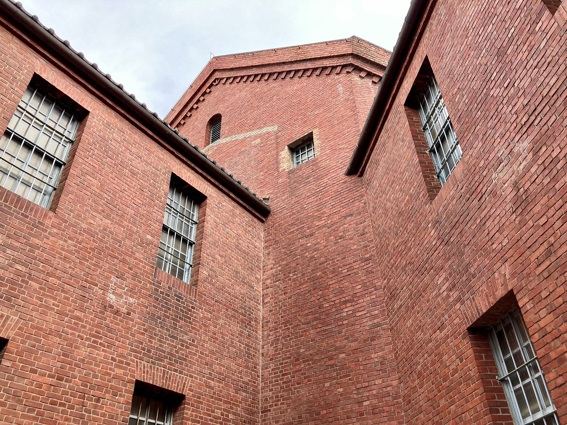 A corner of the prison buildings and their walls.