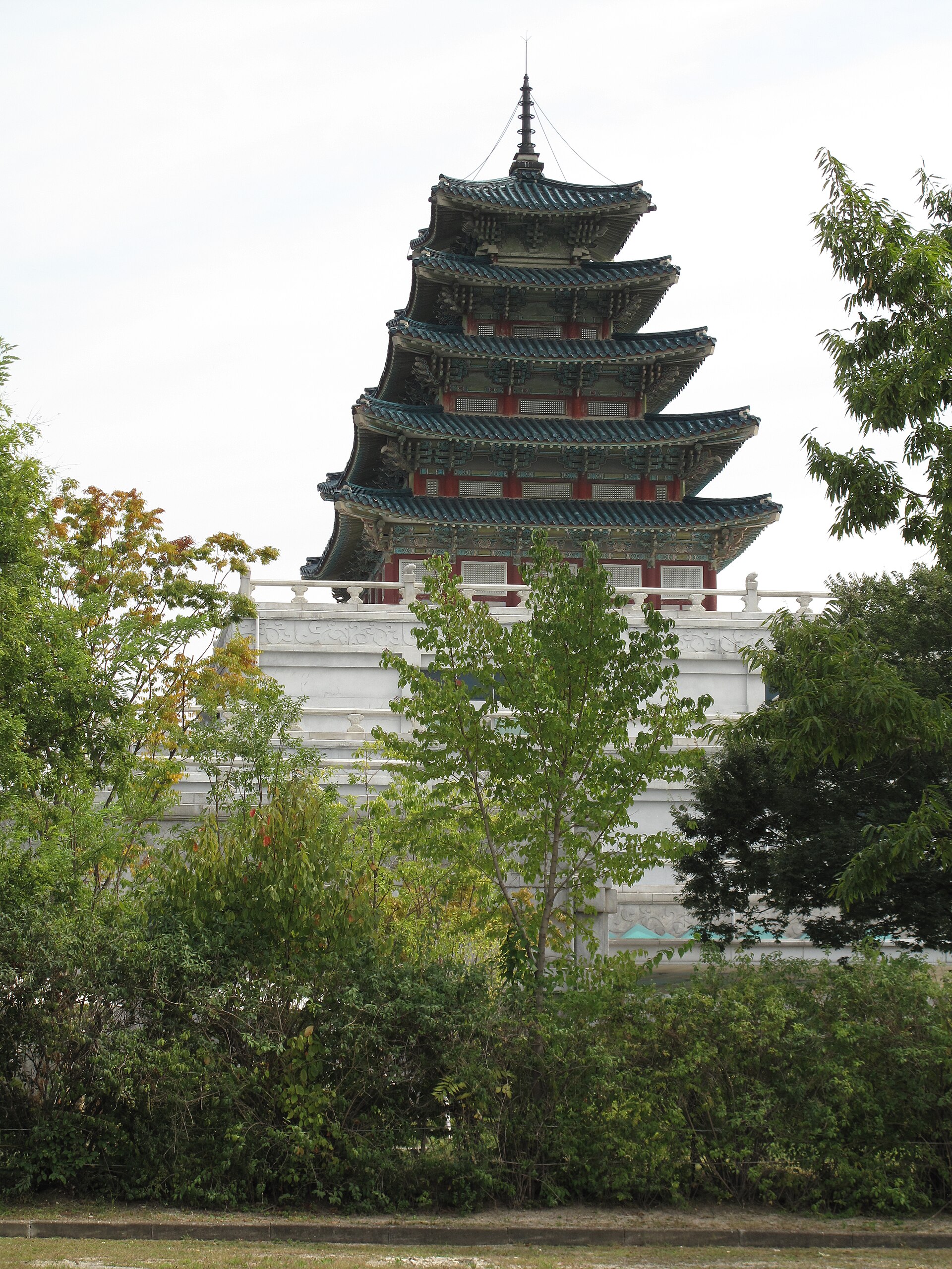 The upper museum building seen through trees.
