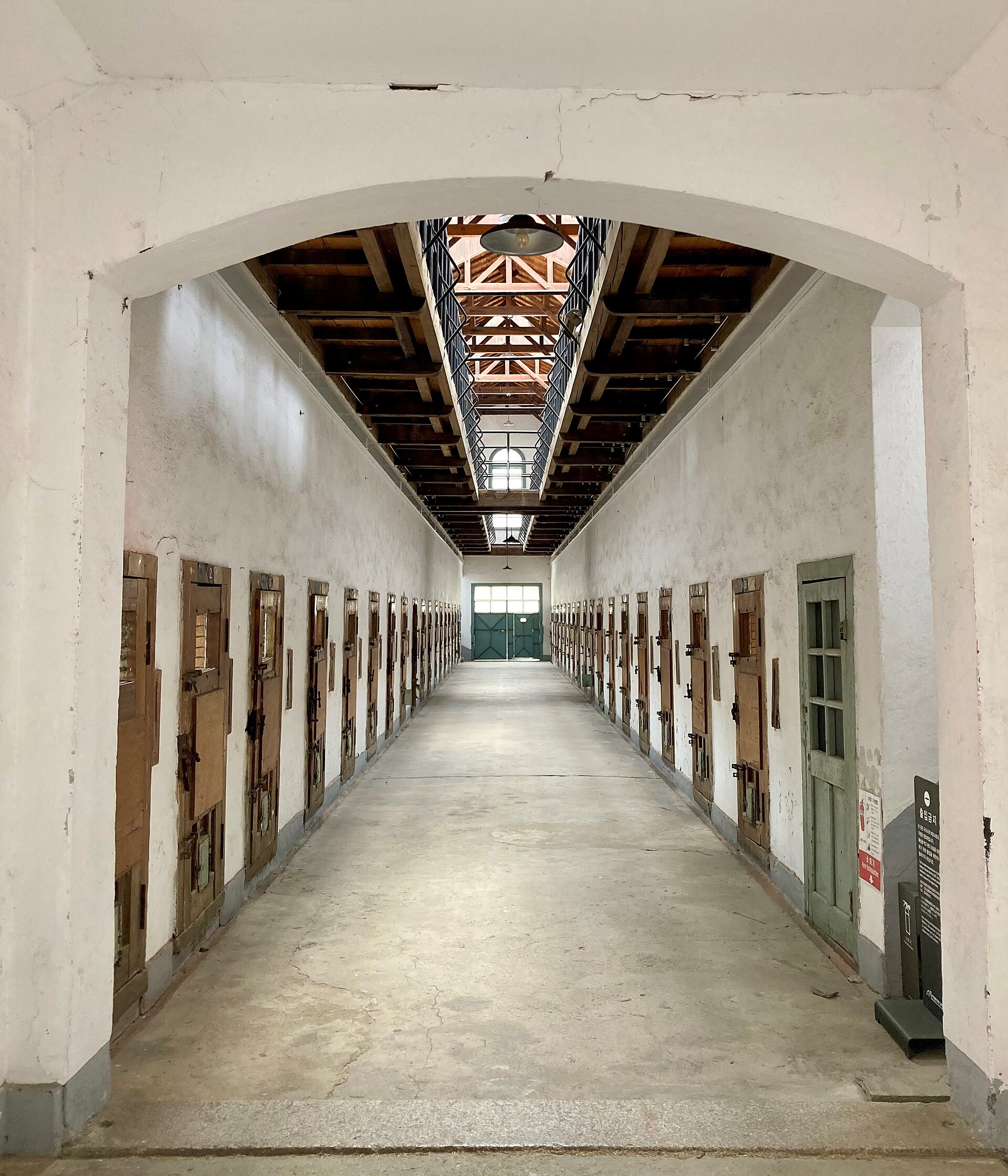 A corridor lined with cell doors.