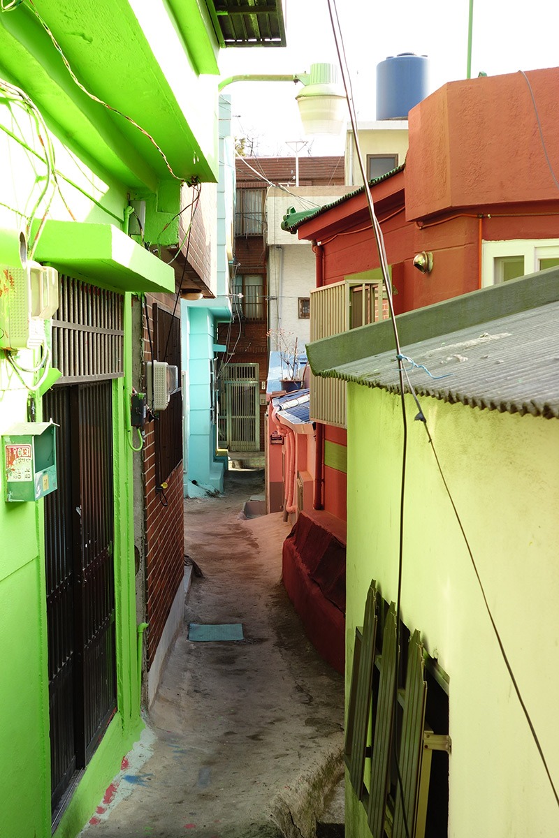 A narrow residential lane between colourful houses in Gamcheon