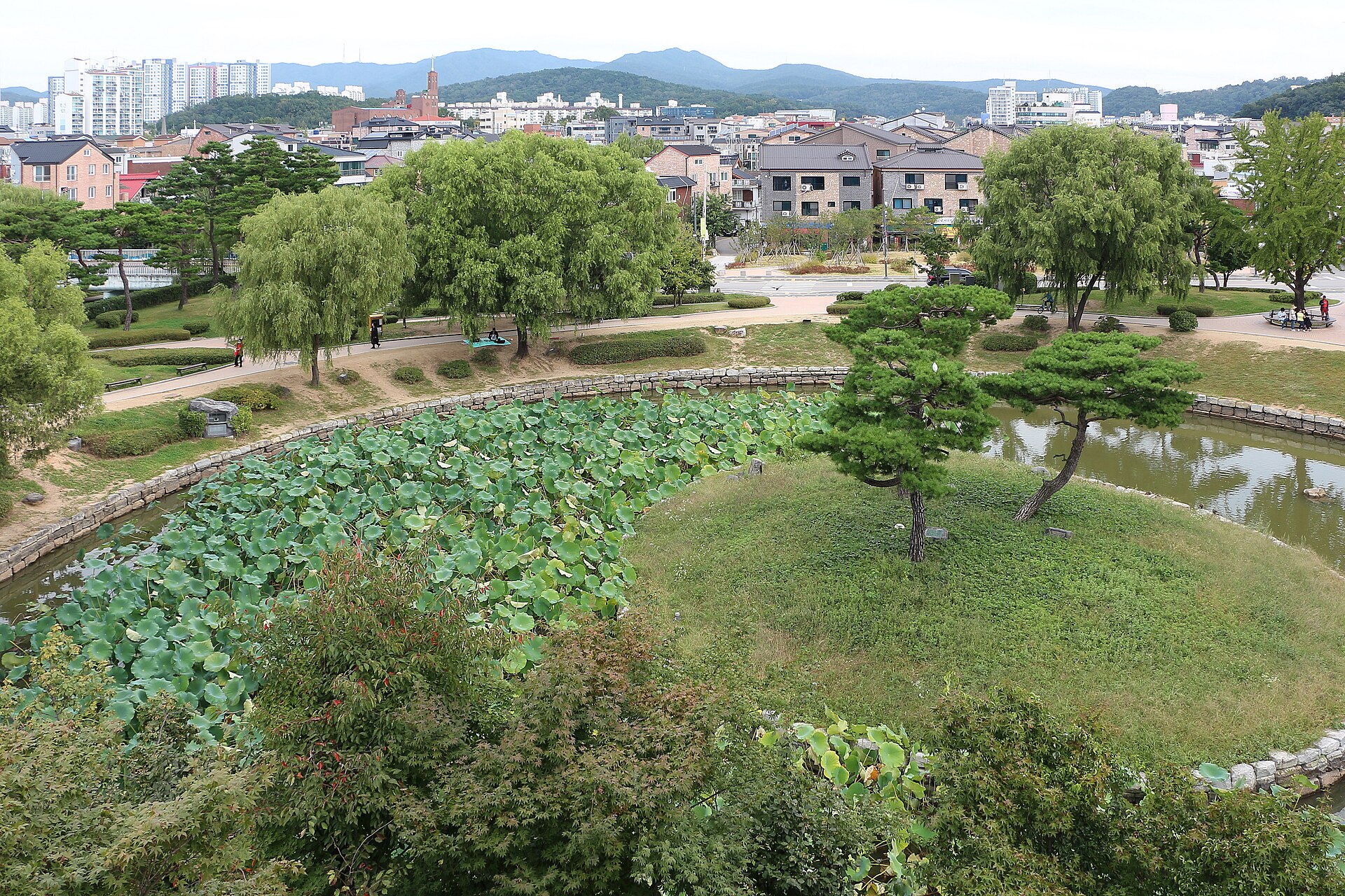 Pond, trees and surrounding neighborhood seen from Banghwasuryujeong in September 2022