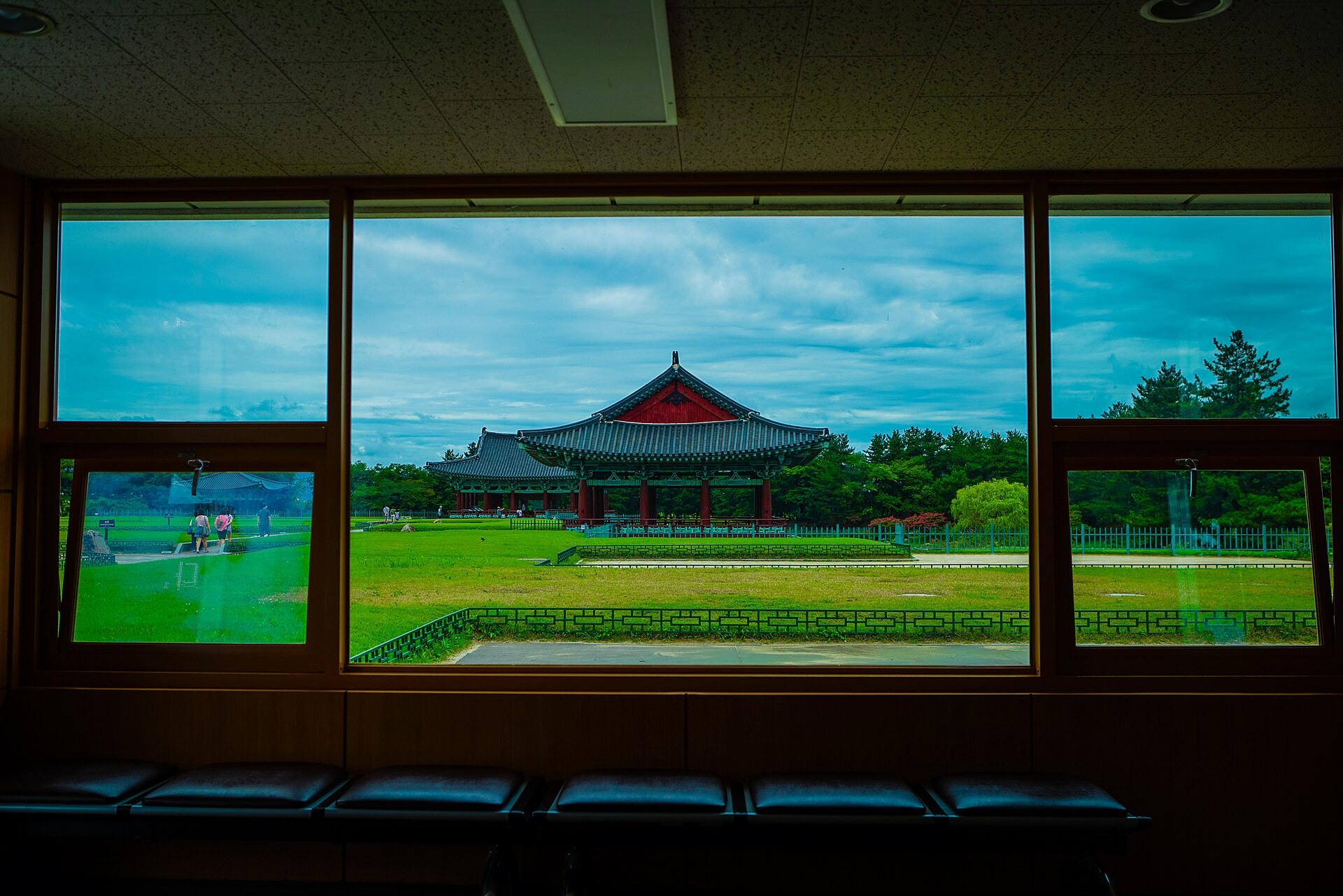 Framed view through a pavilion window at the pond