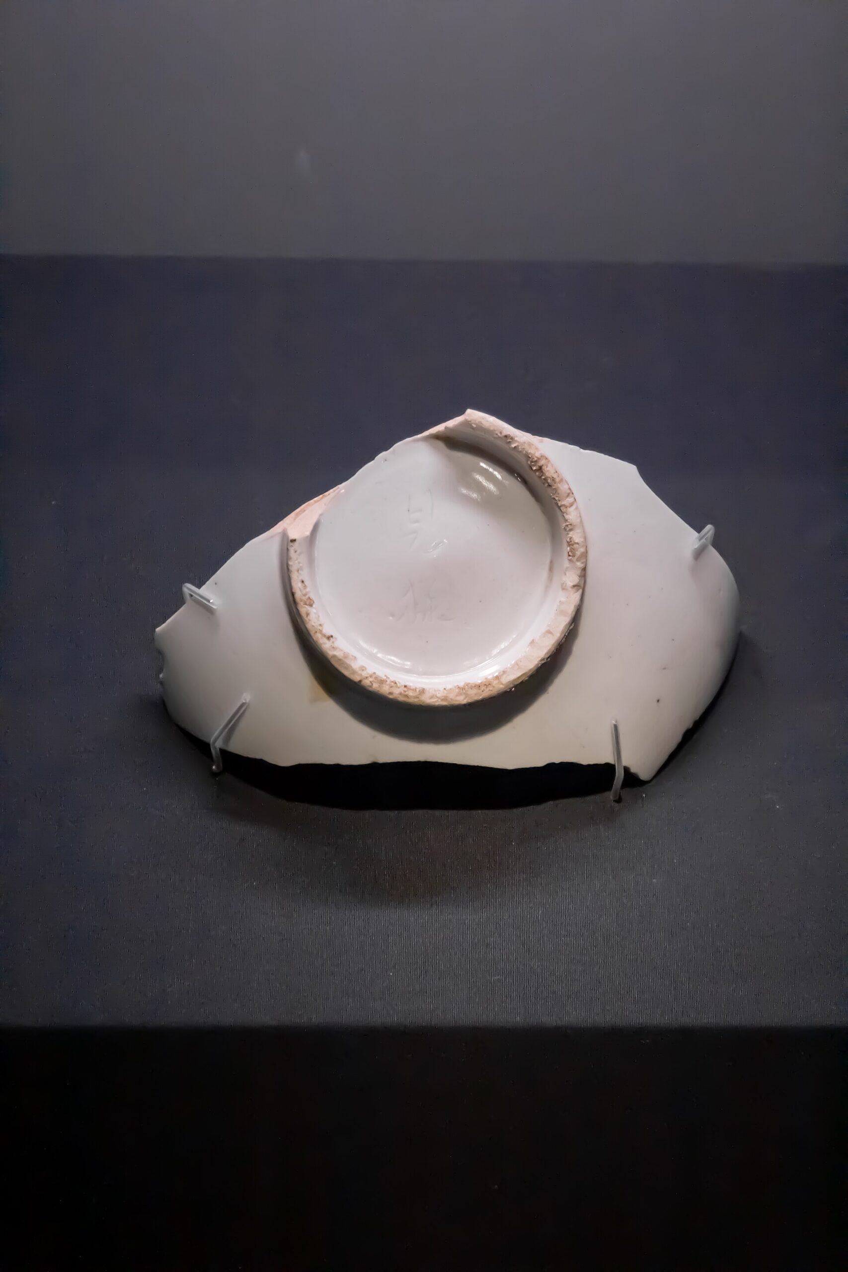 Underside of a ceramic fragment photographed at the museum in December 2024