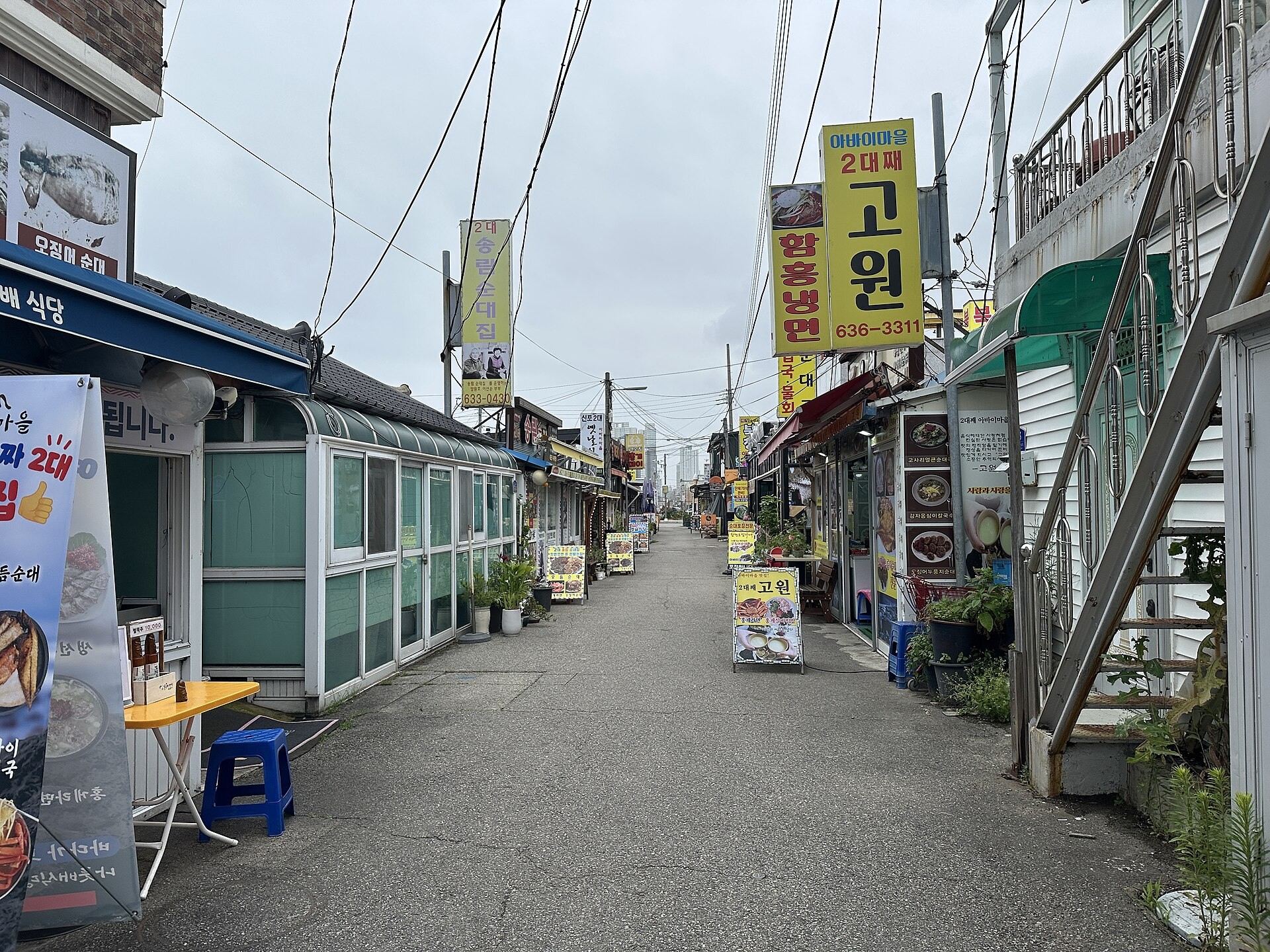 Restaurant signs along a narrow village lane