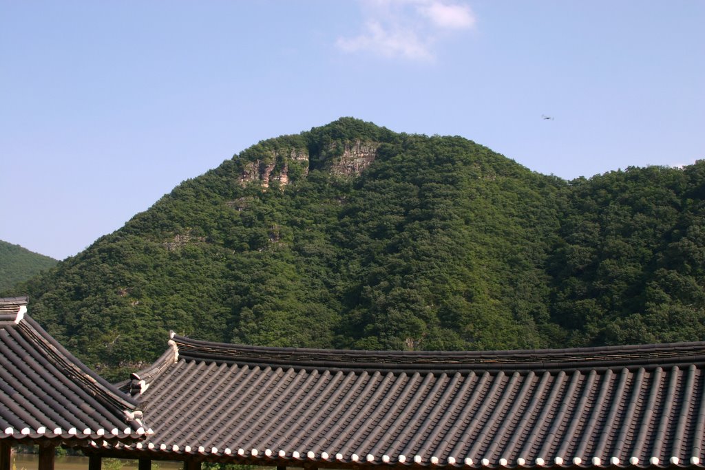 A Byeongsan Seowon roof with the hillside rising behind it
