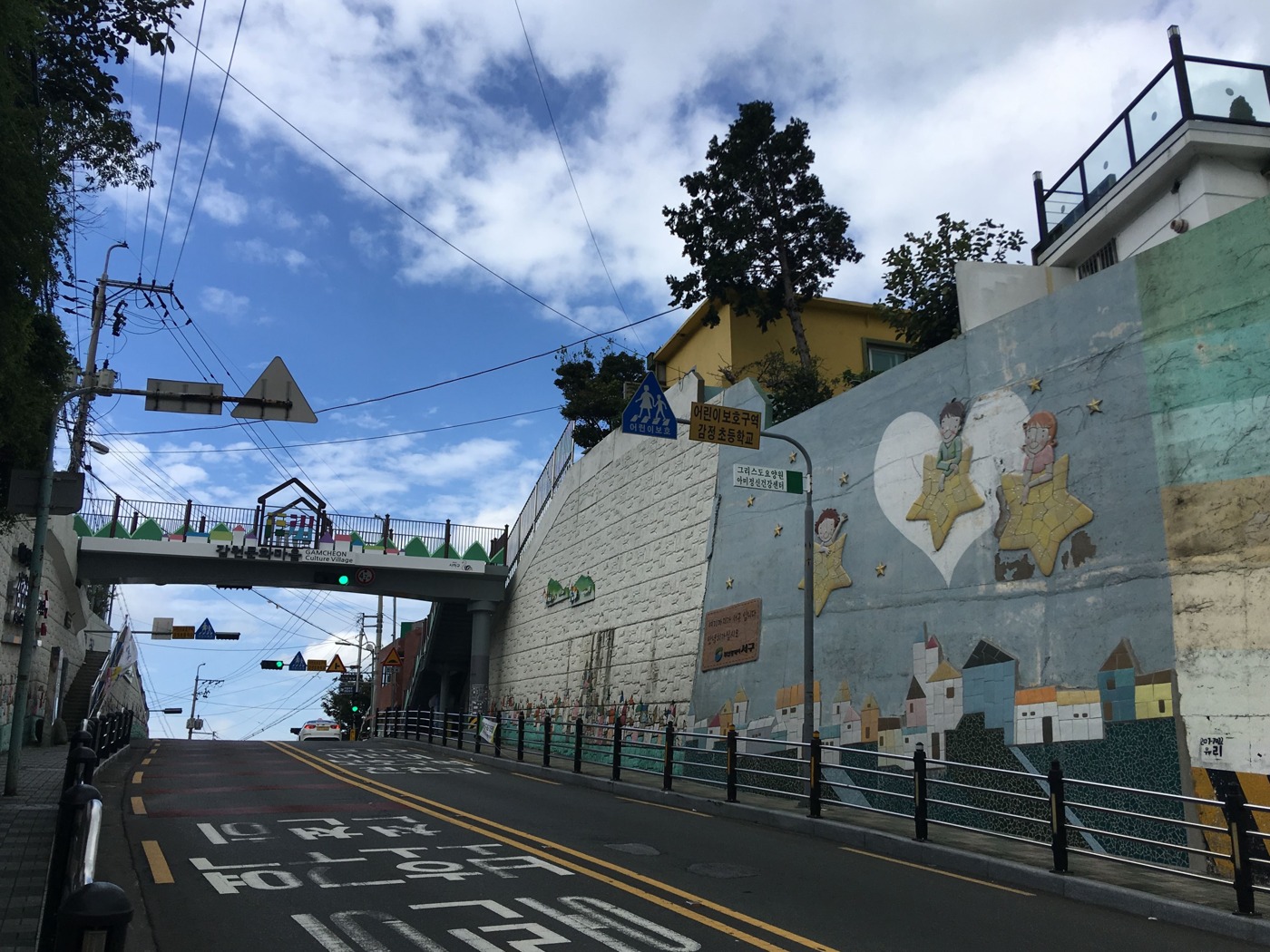 The uphill road and entrance sign near Gamcheon Culture Village