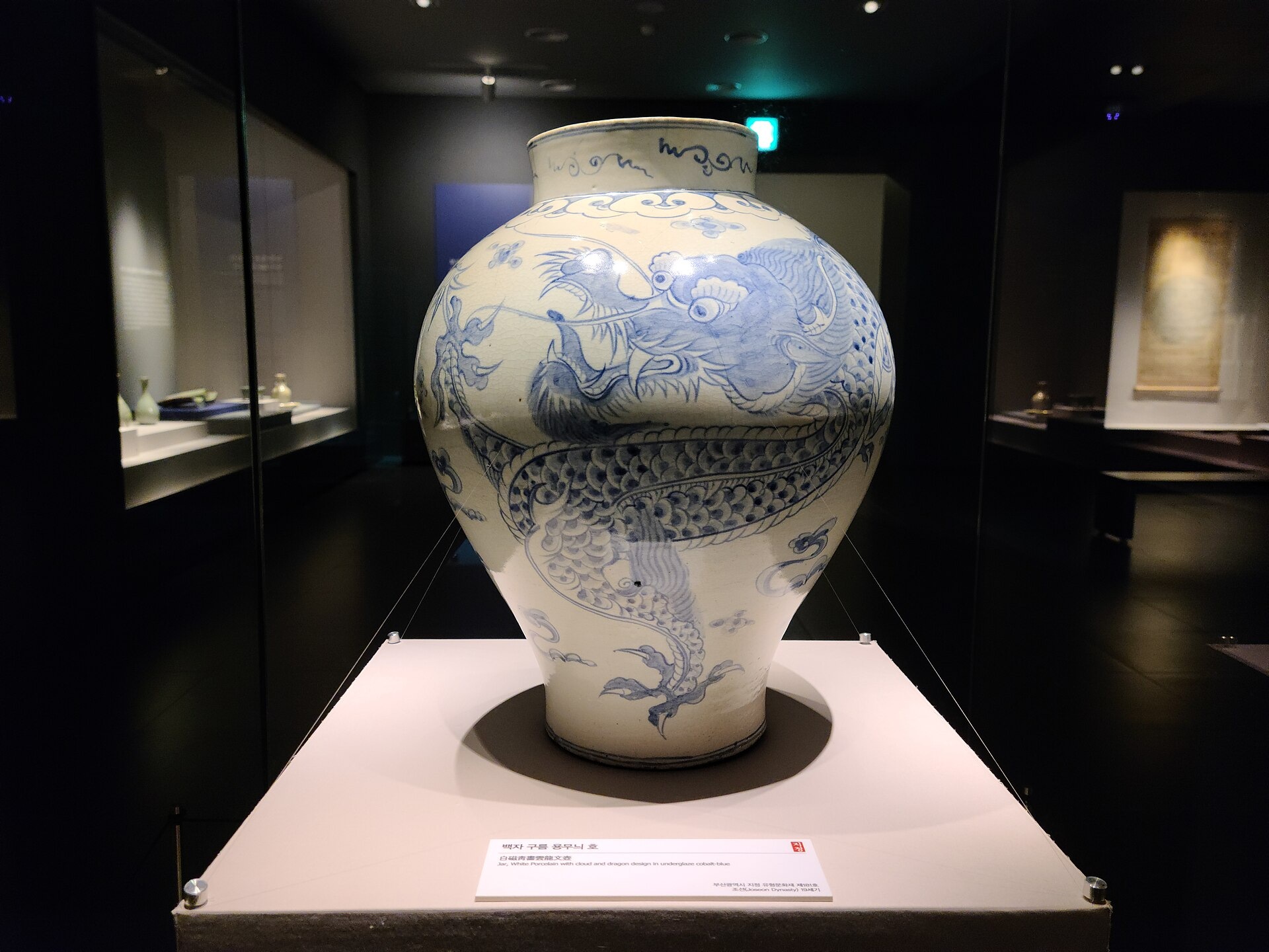 A white porcelain jar decorated with a blue dragon at Busan Museum